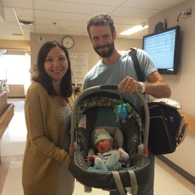HuffPost Canada parents editor Natalie Stechyson leaves the hospital after the birth of her son in 2016. She is wearing an XL tank top and cardigan from the designer "Joe Fresh," maternity leggings, an industrial-strength pad, and flip flops, also from the designer "Joe Fresh."