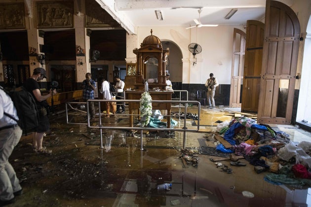Sri Lankan journalists take pictures inside St. Anthony's Shrine in Colombo on April 26, 2019, following...