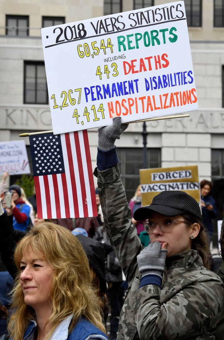 Demonstrators stand in the rain while protesting against legislation to narrow exemption to state-mandated vaccines at a rally at the state Capitol on Tuesday.