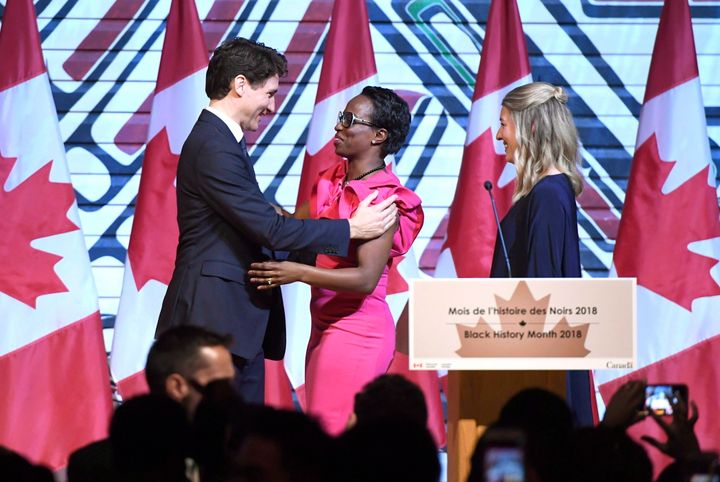 Prime Minister Justin Trudeau is welcomed by MP Celina Caesar-Chavannes, as then-Heritage Minister Melanie Joly looks on, during a Black History Month reception at the Museum of History in Gatineau, Que., on Feb. 12, 2018. 