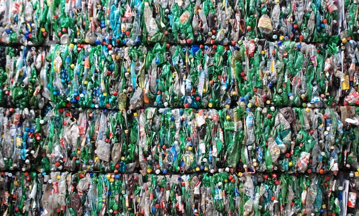 Bales of empty plastic bottles, crushed flat for transport.