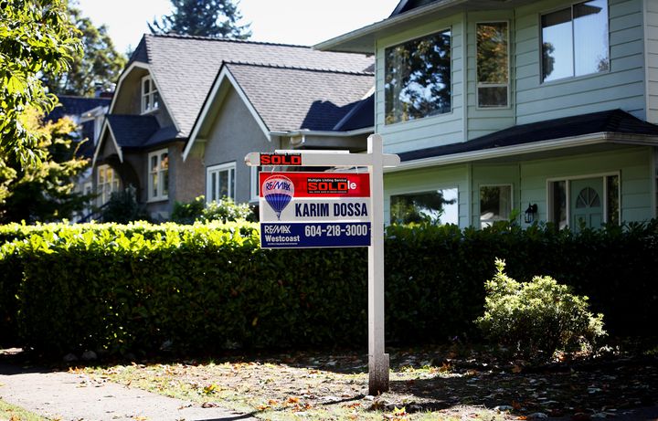 A real estate for sale sign is pictured in front of a home in Vancouver, B.C., Sept. 22, 2016.