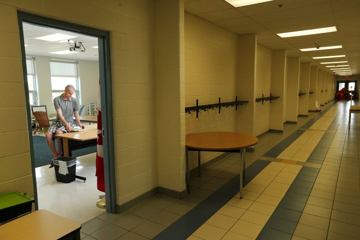 A teacher organizes his empty classroom in a Brampton, Ont. school in Aug. 31, 2015.