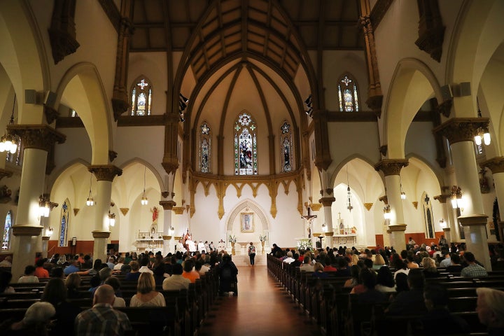 People attend a Mass at the Cathedral Shrine of the Virgin of Guadalupe, the mother church of the Roman Catholic Diocese of D