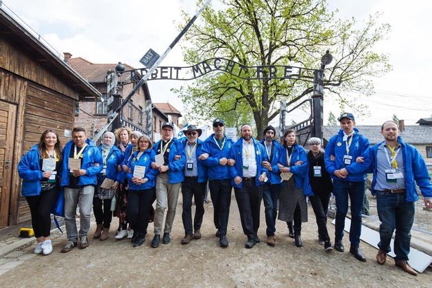 Leaders from all faiths linked arms and marched, as one, out (not in) through the gates of Auschwitz