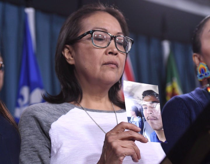 Debbie Baptiste, mother of Colten Boushie, holds a photo of her son during a press conference on Parliament Hill in Ottawa on Feb. 14, 2018.