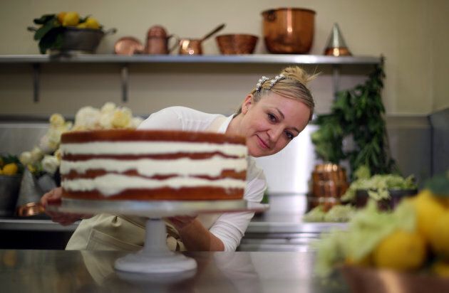 Claire Ptak puts the finishing touches on the wedding cake in the kitchens of Buckingham Palace in London, on May 17, 2018.