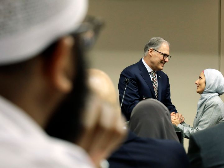 Washington Gov. Jay Inslee (D-Wash.), center, greets Muslim constituents on March 21. As Muslim political engagement has grown, politicians have shown greater interest in outreach.