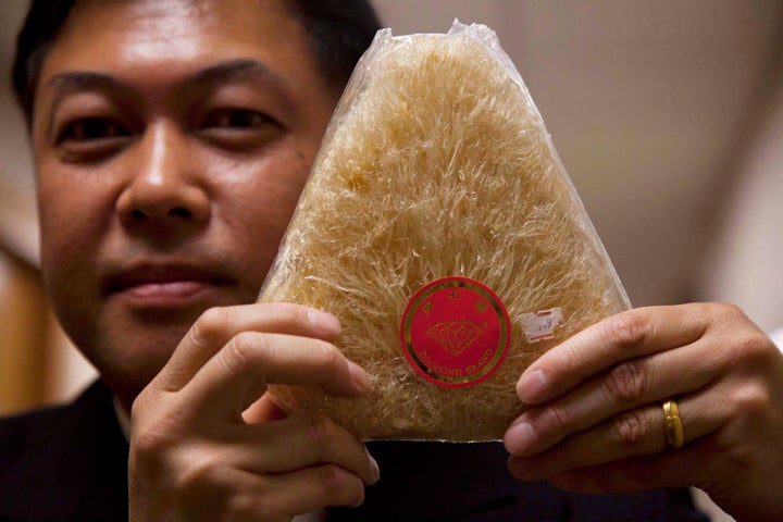 Kerry Jang holds up a shark fin after using it as a prop in the Vancouver City council chamber on Sept. 18, 2012.