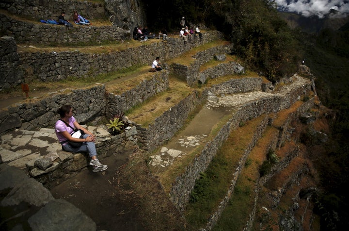 A tourist rests while sitting on terraces at the Inca citadel of Machu Picchu in Cuzco, Peru, in 2015.