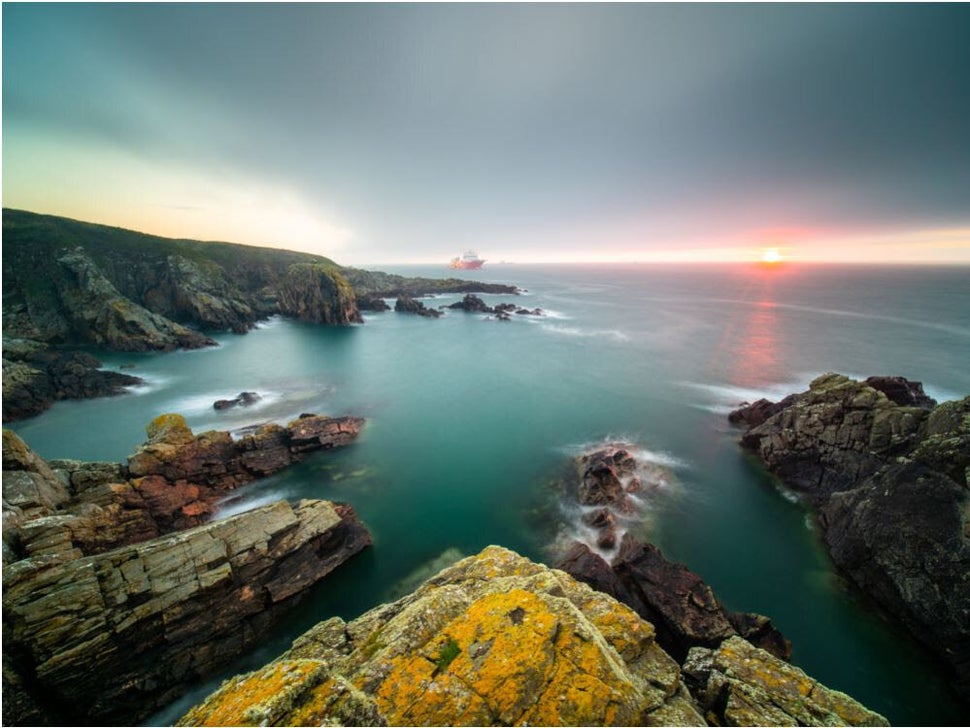 Scottish sunrise: A boat traverses the horizon in this stunning shot captured from the coast of Aberdeen. 