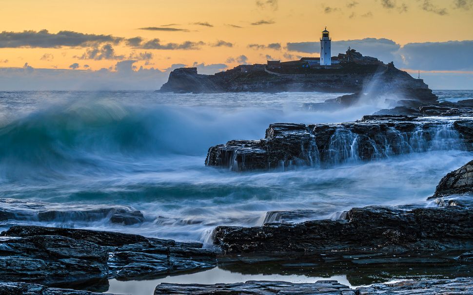 The storm before the rest: Waves break on the rocks of Godrevy, Cornwall on an otherwise quiet evening.