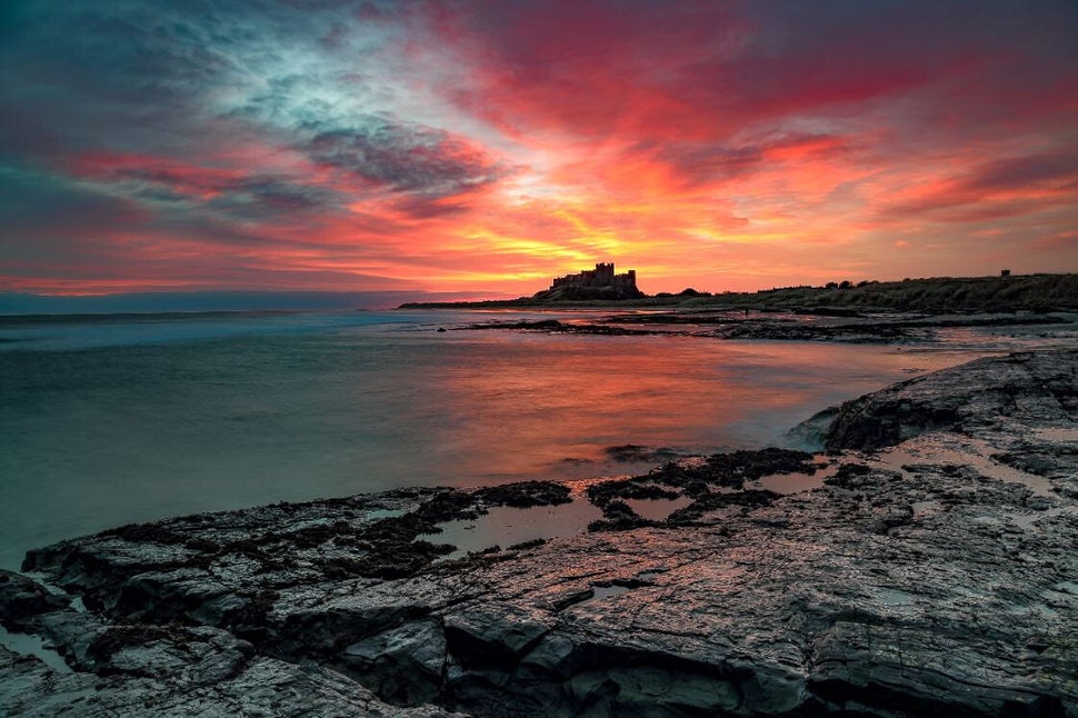 Sunrise explosion: A sunrise combined with low tide makes for a stunning image of Bamburgh Castle, Northumberland taken from the North Beach.