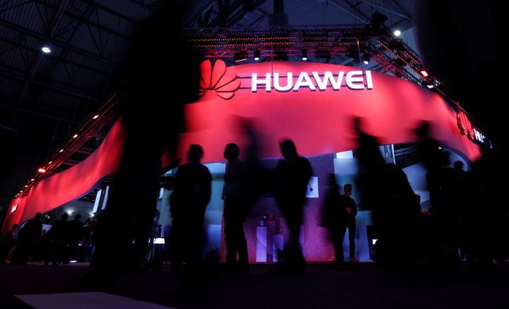 Visitors walk past Huawei's booth during Mobile World Congress in Barcelona, Spain, February 27, 2017.