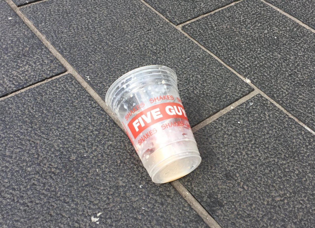 A Five Guys milkshake is left discarded on a Newcastle street after it was thrown over Nigel Farage.