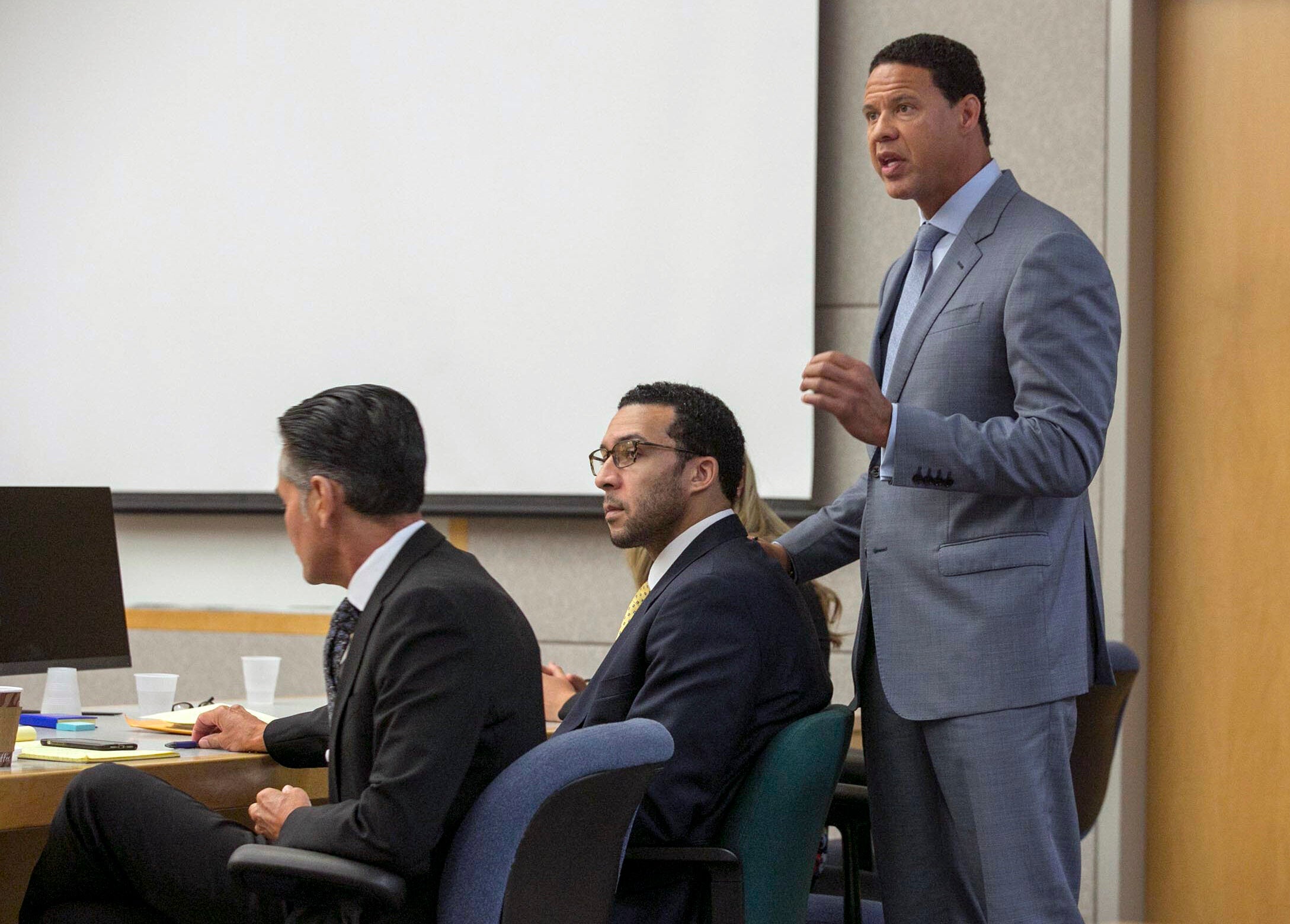 Brian Watkins, right, an attorney for former NFL football player Kellen Winslow II, puts his hands on Winslow as he gives his opening statement to the jury during Winslow's rape trial. (AP)