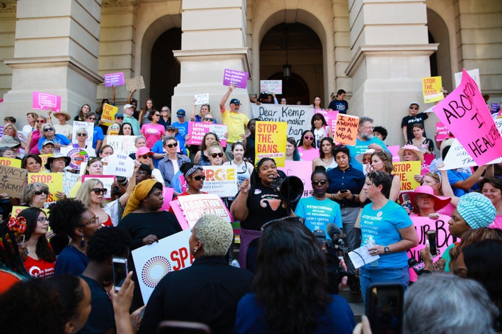 A woman speaks during a protest at the Georgia State Capitol building against recently passed abortion bans on Tuesday.