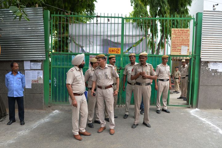Indian police officers stand outside a counting centre.