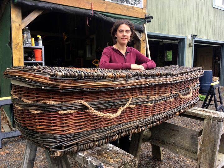 Mary Lauren Fraser stands beside a biodegradable casket she hand-wove from willow, in Montague, Massachusetts.