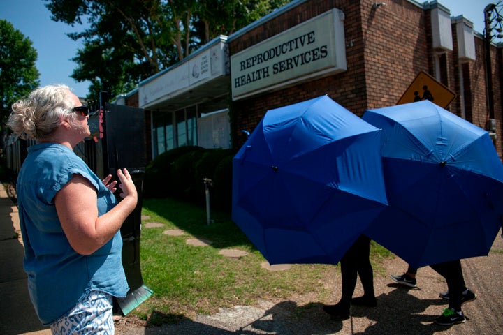 An anti-abortion protester shouts as a woman is escorted into the Reproductive Health Services building in Montgomery, Alabama, on May 20, 2019.