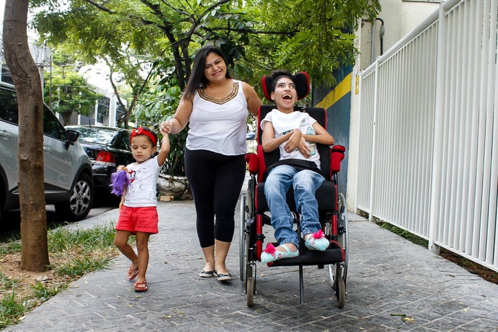 Adenilda Ramos da Silva, with her children: Jennifer, 21, who has cerebral palsy, and Lorena, 2.&nbsp;