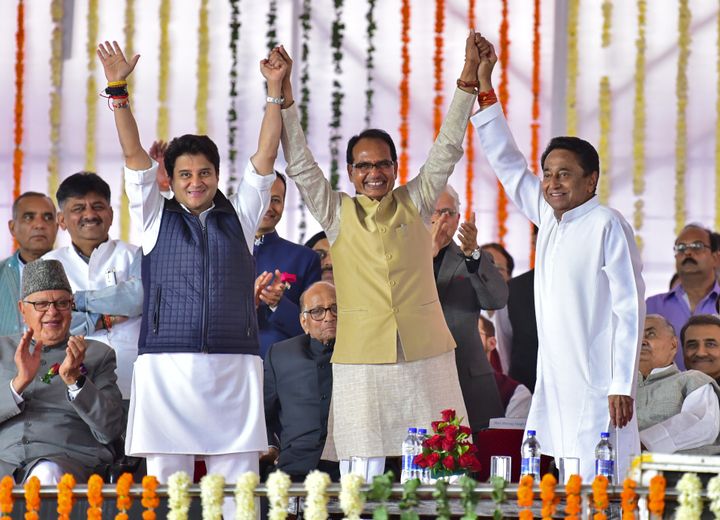 (L-R) Jyotiraditya Scindia, Shivraj Singh Chouhan (C), former Chief Minister of Madhya Pradesh state, and Kamal Nath, Chief Minister, before Nath's oath taking ceremony in Bhopal.