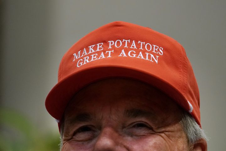 Dan Moss, of the National Potato Council, dons his 'Make Potatoes Great Again' hat before joining U.S. President Donald Trump in the Roosevelt Room at the White House.