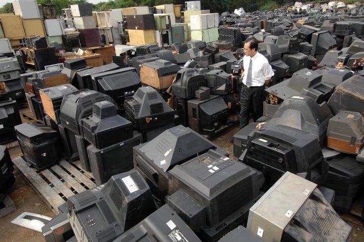 In 1998, Taiwan’s 12 major household electric appliance manufacturers formed a company called E&E Recycling to comply with the country's extended producer responsibility policy. William Sui, an E&E general manger, inspects discarded electronics at the company's recycling center in Yangmei, in northern Taiwan, in May 2007.