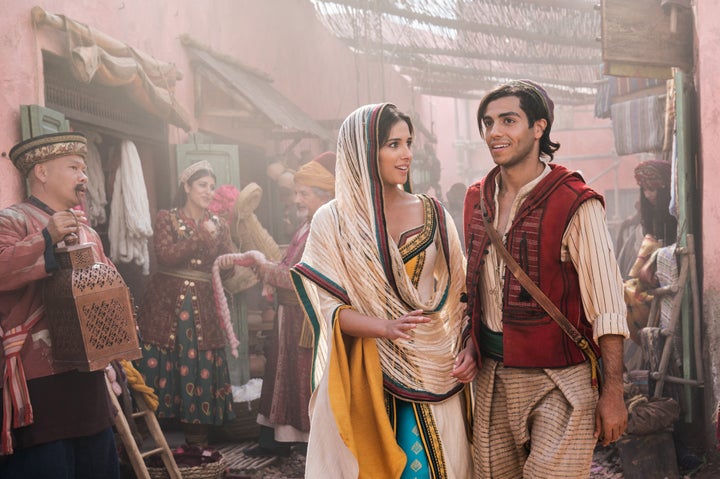 Naomi Scott, as Jasmine and Mena Massoud as Aladdin on the mean streets of Agrabah.