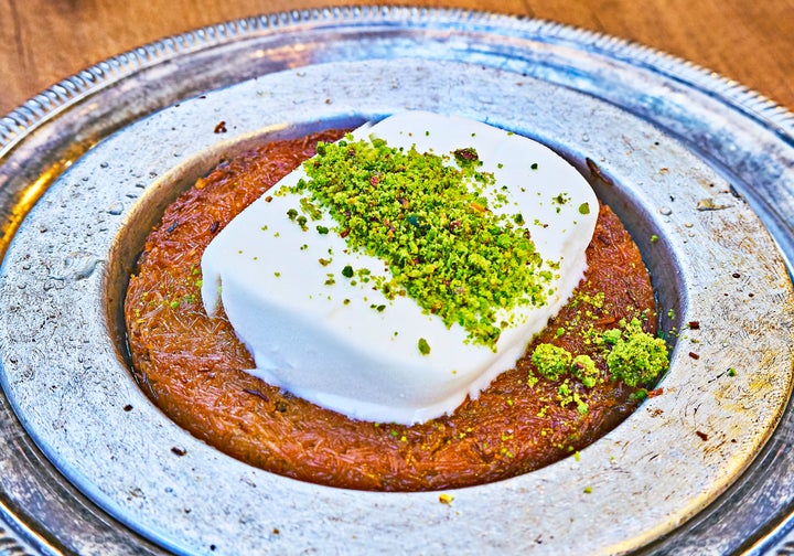 Knafeh is a delicious dessert often served with clotted cream or cheese.