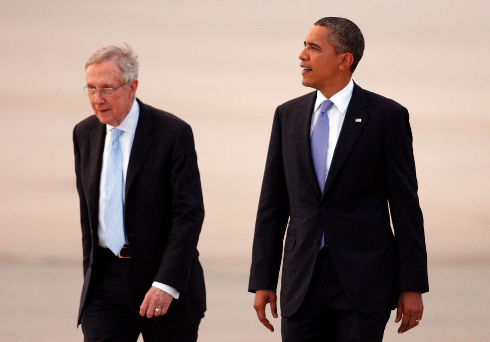 Then-Senate Majority Leader Harry Reid (left) played a significant role in the repeal of 