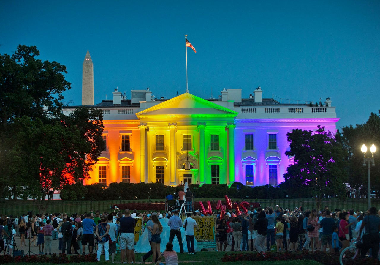 In this June 26, 2015, file photo, people gather in Lafayette Park to see the White House illuminated with rainbow colors in commemoration of the Supreme Court's ruling to legalize same-sex marriage.