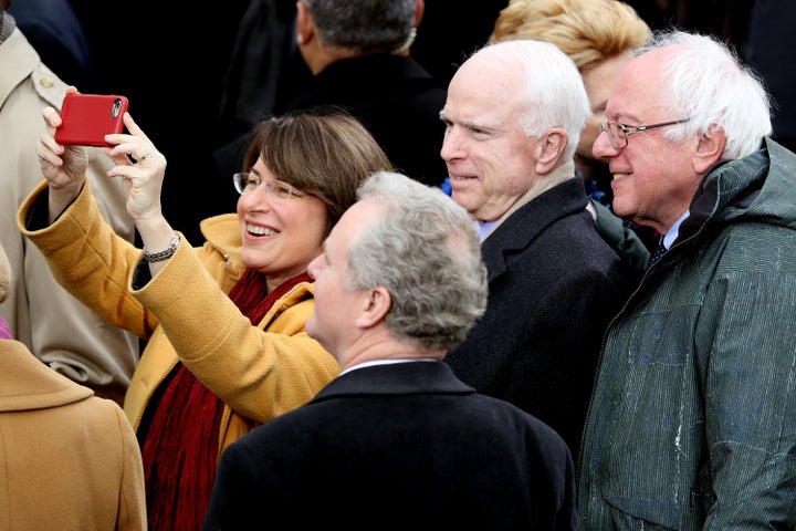 Sen. Amy Klobuchar (D-Minn.) takes a selfie with (from right) Sens. Bernie Sanders (I-Vt.), the late John McCain (R-Ariz.) and Chris Van Hollen (D-Md.) during President Donald Trump's inauguration in 2017.