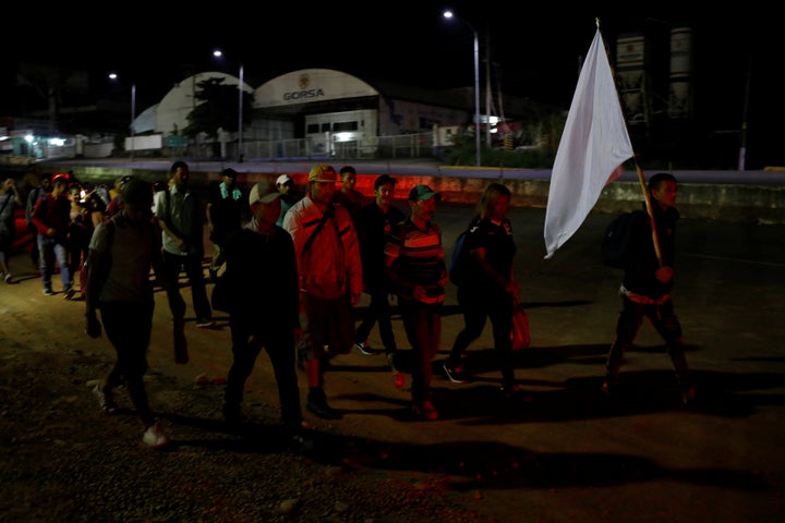 A convoy of Central American migrants walk along a road on the outskirts of Tapachula, Mexico on May 19, 2019.