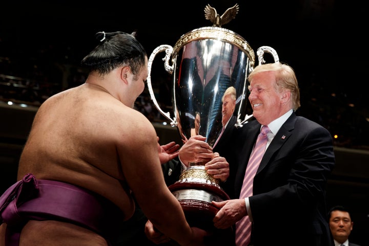 President Donald Trump presents the "President's Cup" to Tokyo Grand Sumo Tournament winner Asanoyama at Ryogoku Kokugikan St