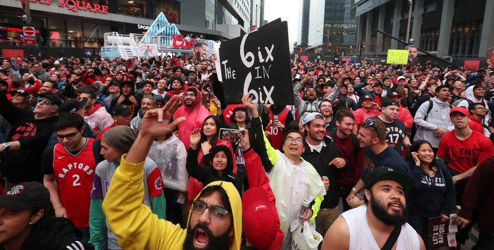 Fans cheer in Jurassic Park as the Toronto Raptors play the Milwaukee Bucks in game six of the NBA Eastern Conference Final on May 25, 2019. 
