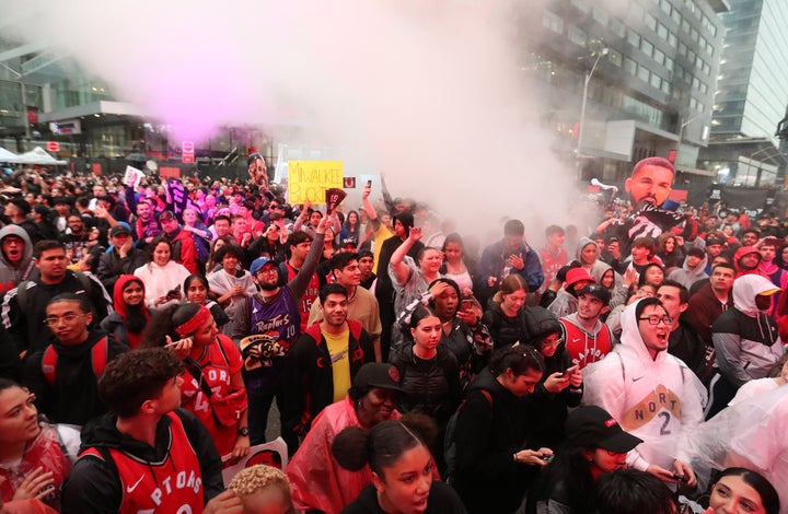 Fans line up in the rain for Jurassic Park as the Toronto Raptors play the Milwaukee Bucks in Toronto on May 25, 2019. 