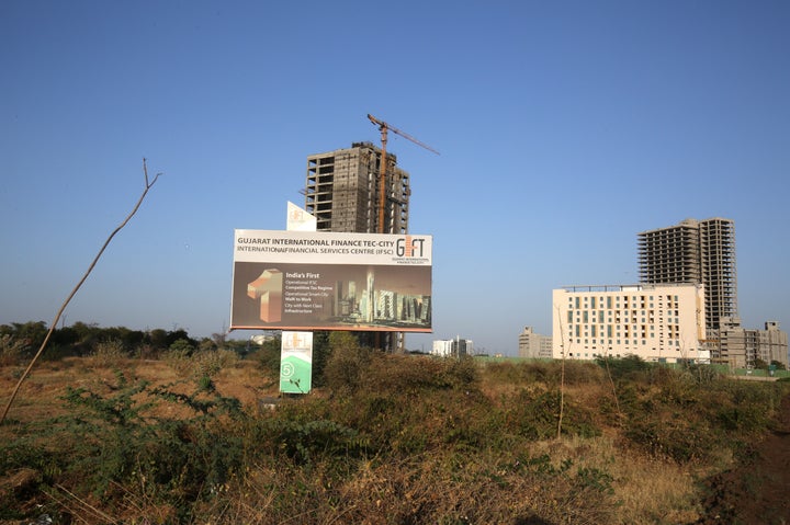 A billboard stands in front of buildings under construction at the Gujarat International Finance Tec-City (GIFT) at Gandhinagar, Gujarat, March 20, 2019.