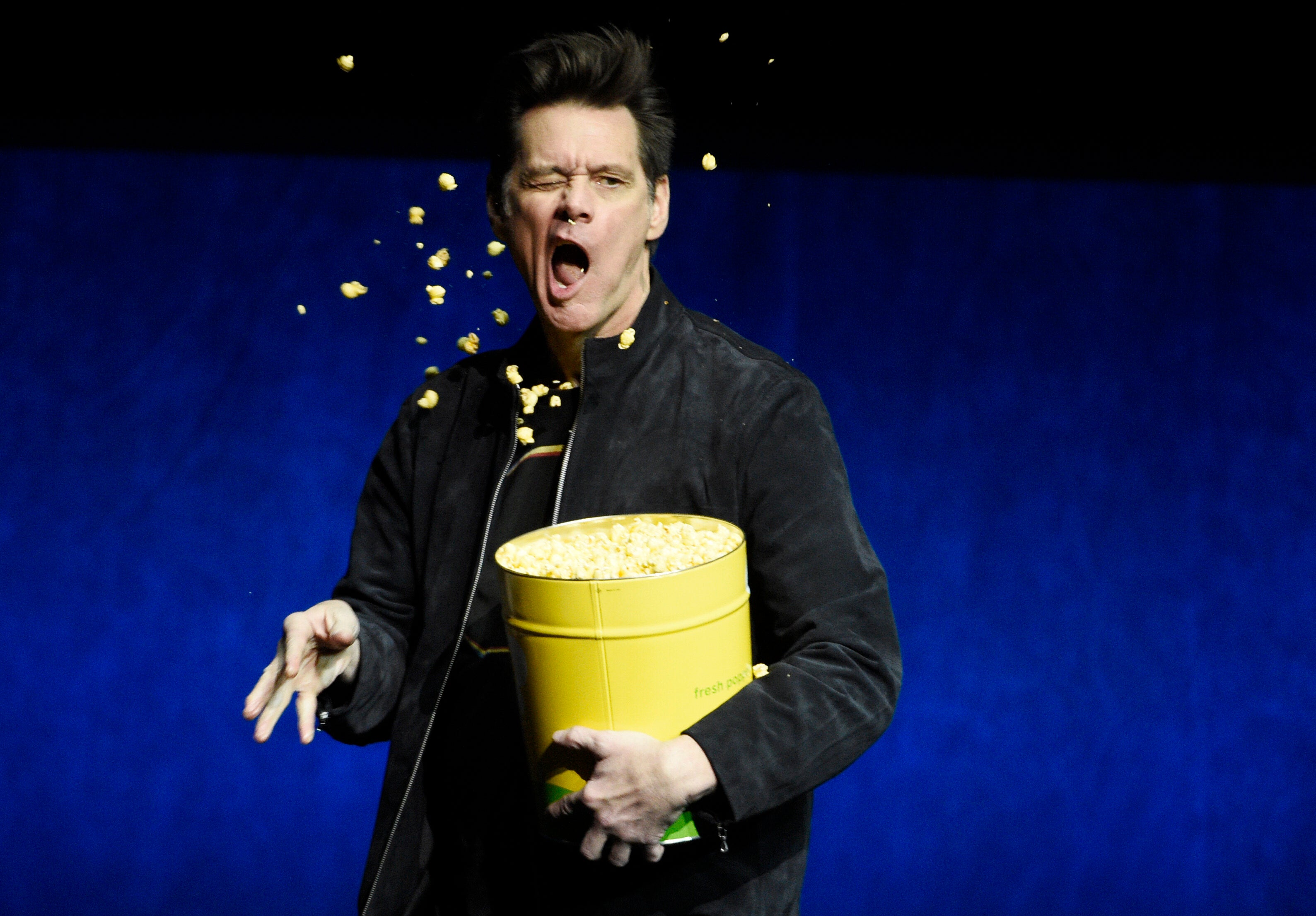 Jim Carrey, a cast member in the upcoming film "Sonic the Hedgehog," throws popcorn into his face during the Paramount Pictures presentation at CinemaCon 2019, the official convention of the National Association of Theatre Owners (NATO) at Caesars Palace, Thursday, April 4, 2019, in Las Vegas. (Photo by Chris Pizzello/Invision/AP)