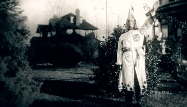 A Klu Klux Klan member posing in a still from the Telus documentary, "Force 136: Chinese Canadian Heroes."