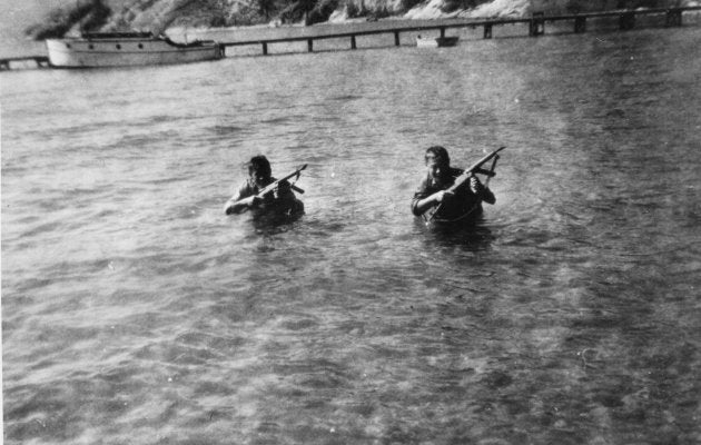 John KoBong and Tom Lock learning to swim silently loaded down with gear in an undated picture.