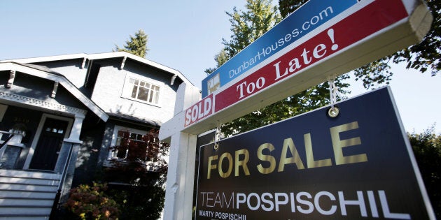 A real estate for sale sign is pictured in front of a home in Vancouver, B.C., Sept. 22, 2016. Real estate now plays a larger role in B.C.'s economy than oil does in Alberta's.