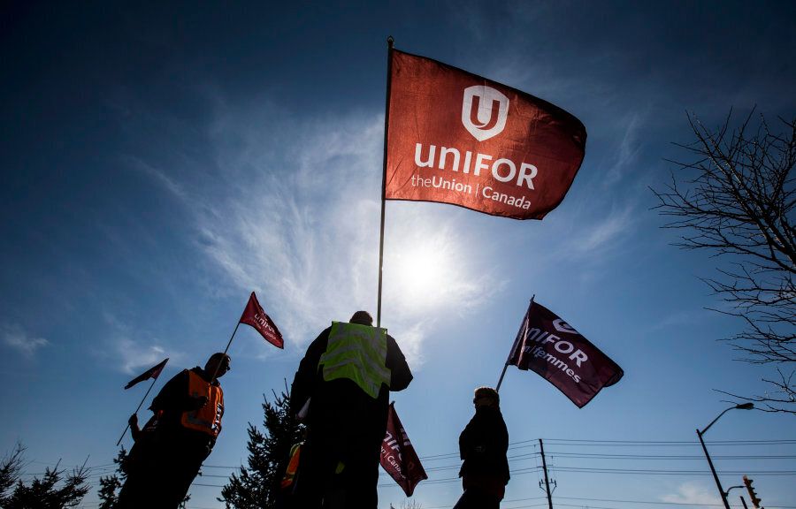 Representatives from Unifor stand outside the Toyota plant in Cambridge, Ont. on March 31, 2014. The union also represents some Air Canada workers.
