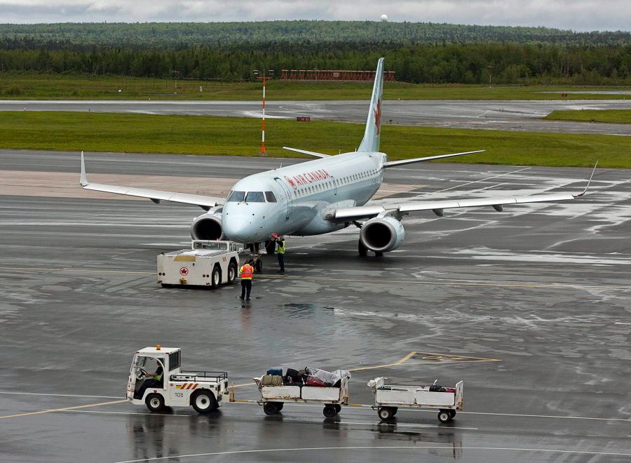 An Air Canada jet is prepared for takeoff at the international airport in Halifax on June 16, 2011.