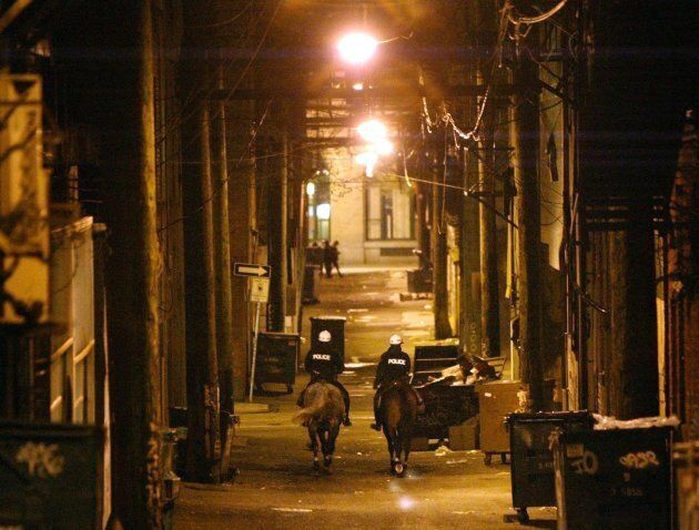 Two mounted Vancouver Police officers patrol one of the many alley ways in Vancouver's Downtown Eastside on April 30, 2003. Community groups at the time were operating an unauthorized safe injection site for drug users.