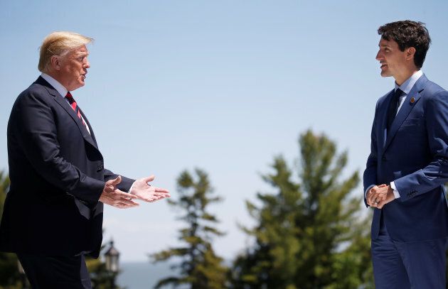 U.S. President Donald Trump approaches Canada's Prime Minister Justin Trudeau as he arrives at the G7 Summit in Charlevoix, Que. on June 8, 2018.