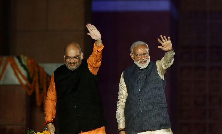 Prime Minister Narendra Modi and BJP President Amit Shah wave at their supporters after the election results at the party headquarters in New Delhi.