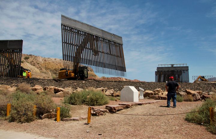 Workers build a border fence on private property located in the limits of Texas and New Mexico on Sunday.