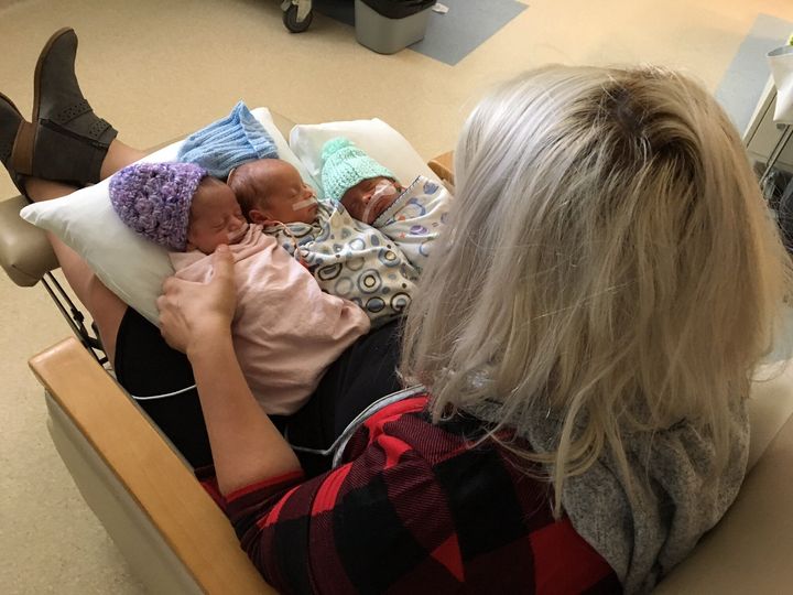 Danielle Johnston hold her triplets. She gave CPR to one while in labour with the others.