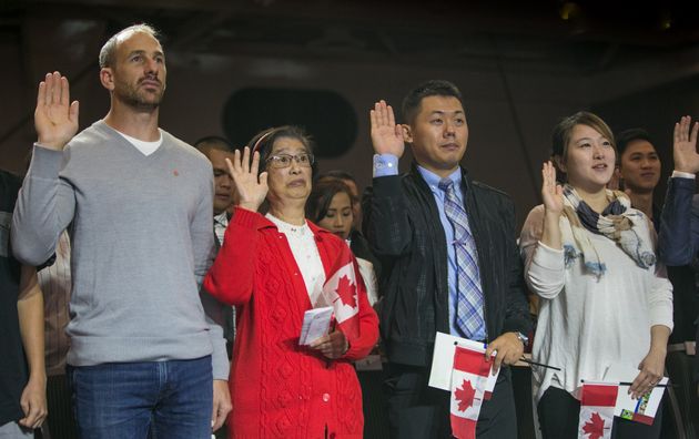 New citizens swear their allegiance to Canada during a citizenship ceremony in Vancouver on July 1, 2016. A new bill proposed by the Liberals aims to change the words of Canada's oath of citizenship.